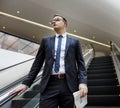 Business Man Walking Down Escalator Concept Royalty Free Stock Photo