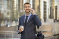 Business man walking talking on cell phone Royalty Free Stock Photo