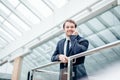 Business man walking while talking on mobile phone on his way to work Royalty Free Stock Photo