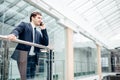 Business man walking while talking on mobile phone on his way to work Royalty Free Stock Photo