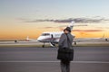 Business man walking toward a private jet Royalty Free Stock Photo