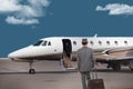 Business man walking toward a private jet Royalty Free Stock Photo