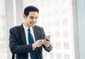 Business man walking and using mobile phone to chatting with fri Royalty Free Stock Photo