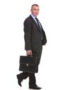 Business man walks with briefcase and looks at you Royalty Free Stock Photo