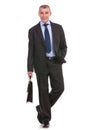 Business man walks to the camera with brief in hand Royalty Free Stock Photo