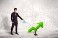 Business man watering green plant arrow Royalty Free Stock Photo