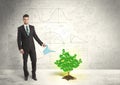 Business man watering a growing green dollar sign tree Royalty Free Stock Photo