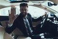 Business Man Waving Hand while Driving Car Royalty Free Stock Photo