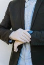 Business man wearing gloves looks the watch. Coronavirus : business man with gloves touches his watch. Royalty Free Stock Photo