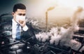 Business man wearing mask against smog and air pollution factory background