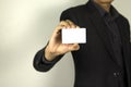 Business Man wearing smart suit and holding whit ID card in his hand, A smart man holding white mock up card, used in card design Royalty Free Stock Photo