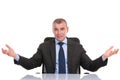 Business man welcomes you from his desk Royalty Free Stock Photo