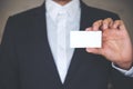 A business man in white shirt and gray suit showing empty business card Royalty Free Stock Photo