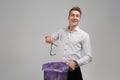 Young man throws glasses in trash isolated on white background