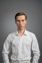 Business man in white shirt, portrait on grey background.