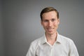 Business man in white shirt, portrait on grey background.