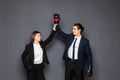 Business man and woman in boxing gloves win gesture isolated on gray background Royalty Free Stock Photo