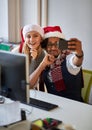 Business Man and woman celebrating winter holidays together at work and  take selfie in santa hat Royalty Free Stock Photo