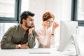 Business man and woman colleagues looking at computer trying to solve problems in office Royalty Free Stock Photo