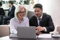 Business man and woman colleagues looking at laptop happy smiling Royalty Free Stock Photo