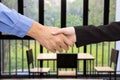 Business man and woman handshake on blured meeting room background Royalty Free Stock Photo