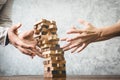 Asian man and woman playing wood jenga game. Royalty Free Stock Photo