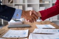 business man and woman are shaking hand in office, Business handshaking, businessmen shake hand after the meeting was