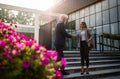 Business man and woman shaking hands in front of offic ebuilding Royalty Free Stock Photo