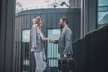 Business man and woman shaking hands near office building Royalty Free Stock Photo