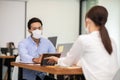 Business man and woman wearing face mask meeting and working together for discussion and brainstroming Royalty Free Stock Photo