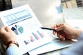 Business man working and analyzing financial figures on a graphs on a laptop outside Royalty Free Stock Photo