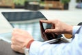 Business man working and analyzing financial figures on a graphs on a laptop outside. Royalty Free Stock Photo