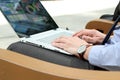 Business man working and analyzing financial figures on a graphs on a laptop outside Royalty Free Stock Photo