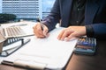 Business man working on desk office ,writing make note and using a calculator at home office. finance accounting concept Royalty Free Stock Photo