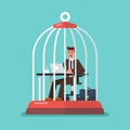 Business man working at desk trapped inside birdcage Royalty Free Stock Photo