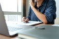 Business man working with graph data in laptop and documents on his desk at office Royalty Free Stock Photo