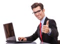 Business man working at his laptop making ok sign Royalty Free Stock Photo