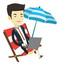 Business man working on laptop at the beach. Royalty Free Stock Photo