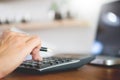 Business man working on a laptop tablet and graph data documents on his desk in home office Royalty Free Stock Photo