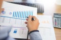 Business man working on a laptop tablet and graph data documents on his desk in home office Royalty Free Stock Photo