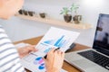 Business man working on a laptop tablet and graph data documents on his desk in home office Royalty Free Stock Photo