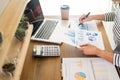 Business man working on a laptop tablet and graph data documents on his desk in home office Royalty Free Stock Photo