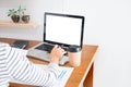 Business man working on a laptop tablet and graph data documents on his desk in home office Royalty Free Stock Photo