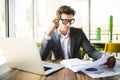 Business man working at office with laptop and documents on his desk. Analyze plans, papers, hands keyboard. Royalty Free Stock Photo