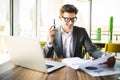 Business man working at office with laptop and documents on his desk. Analyze plans, papers, hands keyboard. Royalty Free Stock Photo