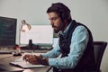 Business man, writing and headphones in office with blank computer screen and notebook. Information technology, coding Royalty Free Stock Photo