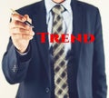 Business man writing TREND text, business concept