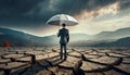 business manager with umbrella in the middle of dry cracked ground Royalty Free Stock Photo