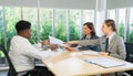 Business manager women looking at working profile showing by African man worker in meeting room. Business group meeting or job Royalty Free Stock Photo