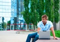 Business manwith laptop in front of modern business building Royalty Free Stock Photo